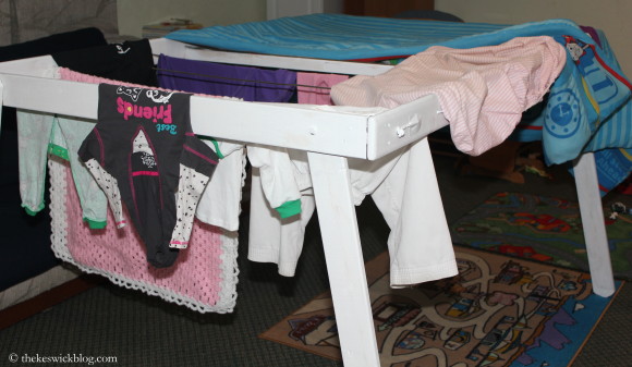 I love this rack. It folds flat for easier storage, holds at least two loads of laundry at a time and will dry two twin-sized comforters at once. It is just the best! :)